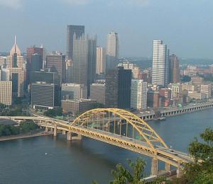 a skyline of Pittsburgh and the Fort Pitt bridge
