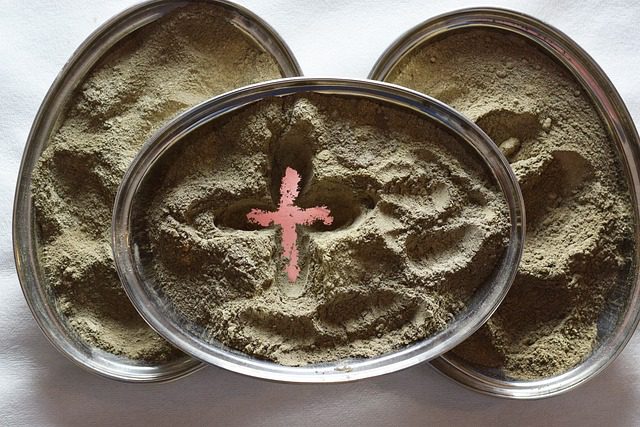 a dish of dust or ashes, with a cross drawn in it