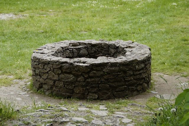 a well surrounded by a stone wall