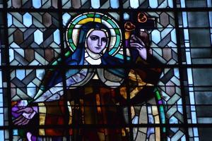 a stained glass window with a picture of a Carmelite nun