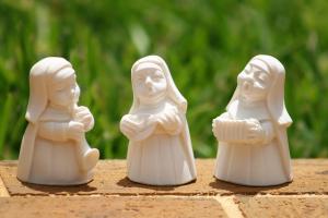 porcelain figures of smiling nuns playing musical instruments