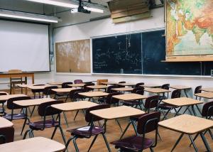 a classroom with desks and a map