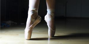 the feet of a ballet dancer standing en pointe