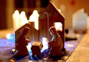 a Nativity scene surrounded by candles