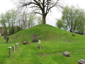 Hodgen's Cemetery Mound, a small cemetery with a dead tree on the top of a cone-shaped mound in the center. 