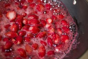 strawberry pieces boiling in a pot