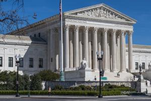 The U. S. Supreme Court building under a bright blue sky