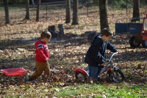 children playing in Autumn leaves