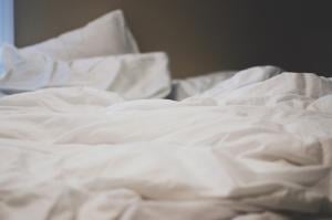 A bad with rumpled pillows and sheets