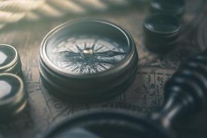 a compass, a magnifying glass, and an old map