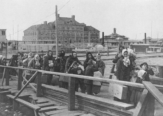 Immigrants arriving at Ellis Island, 1902 (public domain)