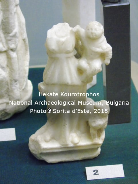 Hekate holding a baby, similar to images of Isis holding Horus