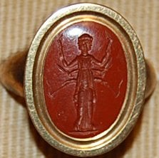 Red Jasper Intaglio, depicting a triple image of Hekate bearing Torches.  © The Trustees of the British Museum