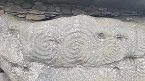 Carving of spirals on New Grange, Ireland. Photo by Sorita d'Este, February 2019