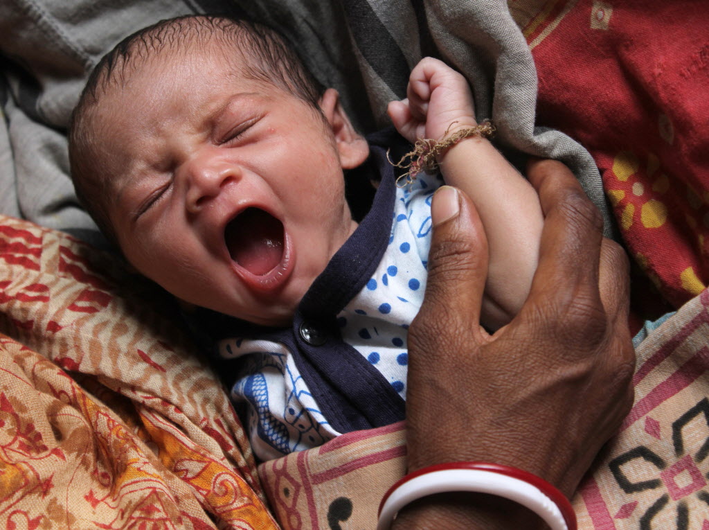 Deepali Mahato sleeps with 14 days old girl in her house at Narudih village