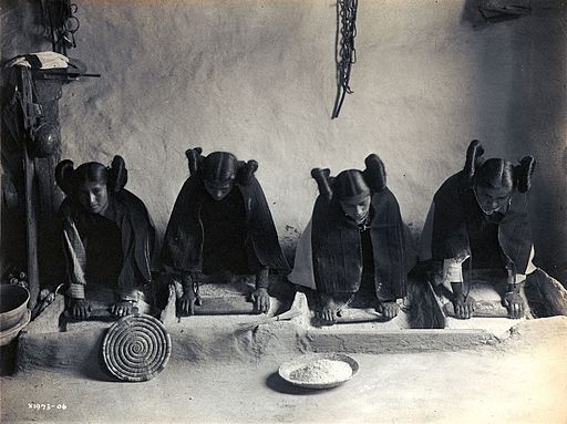 Four young Hopi Indian women grinding grain