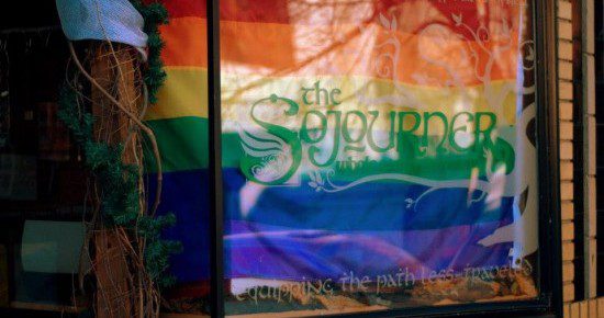 Front Window of The Sojourner Whole Earth Provisions with our Pride Flag