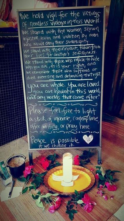 Candle, flowers and a vigil altar seeking peace for the victims of the Orlando Pulse Nightclub masacre.