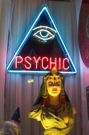 Shop window with neon sign that reads "Psychic"