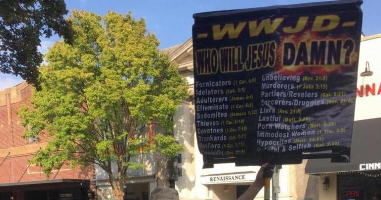 Who Will Jesus Damn? Sign held by EC Street Preacher, Photo by Heron Michelle