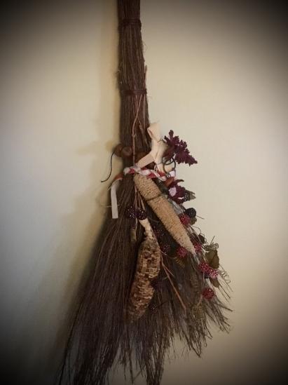 This cinnamon broom hangs beside my altar, with the mementos of Sabbats past: A corn dolly, belled ribbon anklet, hazelnut charm, dried corn cobs, etc. I add and subtract from it regularly.