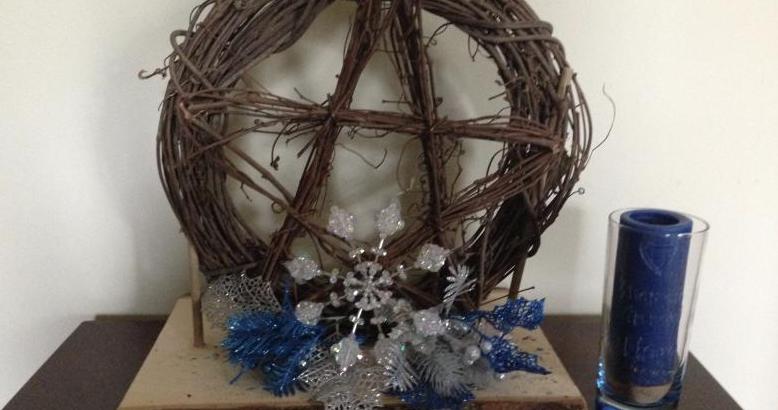 Altar Pentacle Wreath dressed for Imbolc, with dedication candle to the Element of Water - photo by Heron Michelle
