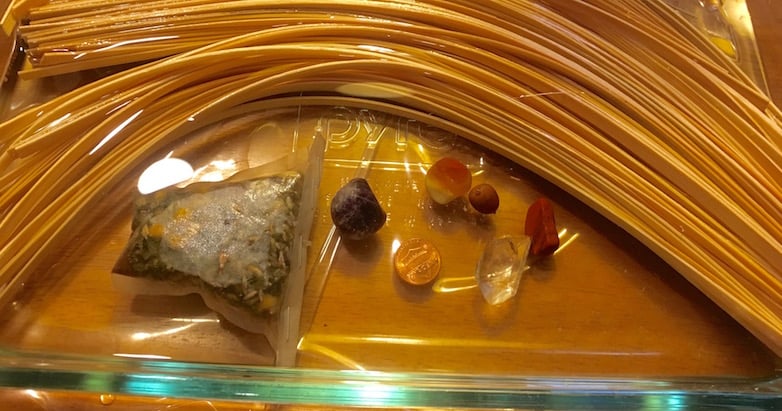 Glass Casserole Dish with Reeds soaking in herb tea water with stones