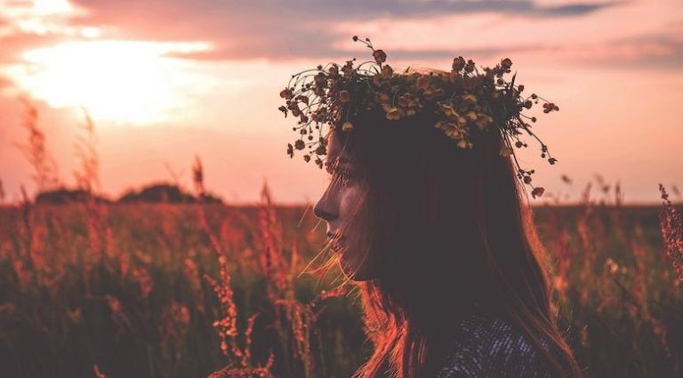 Woman wearing flower crown in sunset