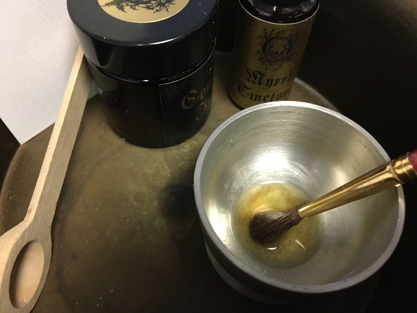 Working with Occvlta's Myrrh Tincture.  Photo by Coby Michael.