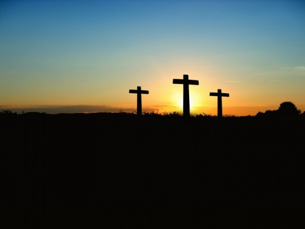 silhouette-of-crosses-on-hill-at-sunset