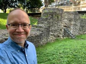 James McGrath next to a Roman wall in Regensburg
