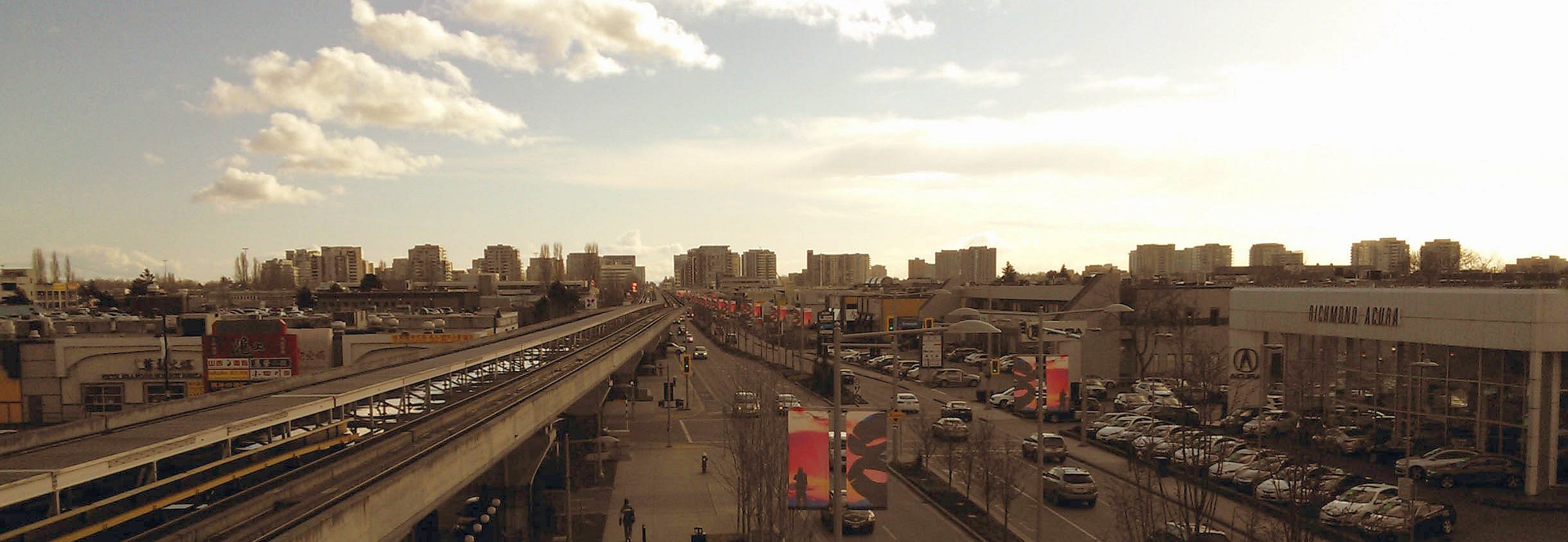 The skyline of Richmond, BC, Canada taken from Aberdeen Station. - by Grotskiii, February 2013 (Richmond_BC_Skyline-1.jpg) (CC BY-SA 3.0 [https://creativecommons.org/licenses/by-sa/3.0/deed.en]), via Wikimedia Commons