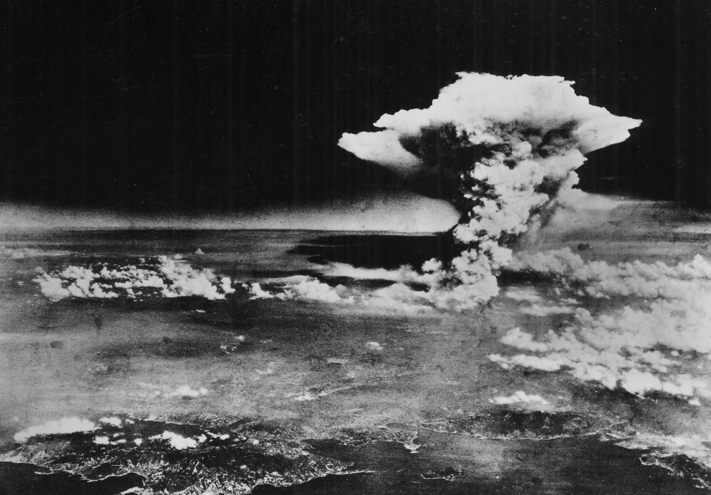 Atomic cloud over Hiroshima, taken from "Enola Gay" flying over Matsuyama, Shikoku (commentary by Chugoku Shimbun), 6 August 1945 - by 509th Operations Group (PD-US), via Wikimedia Commons