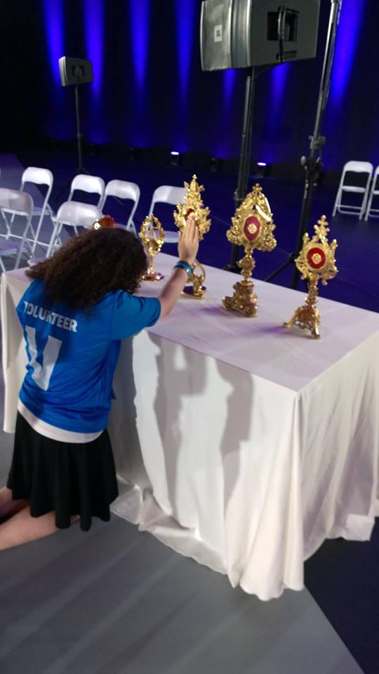 Eugenia venerates the relics of each of the five Polish Saints from the Mercy Centre she has written about, pausing as she as over those of Pope St. John Paul II - photo credit: Lawrence Lam