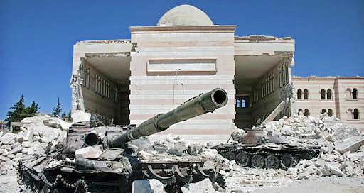 a destroyed building with a tank out front