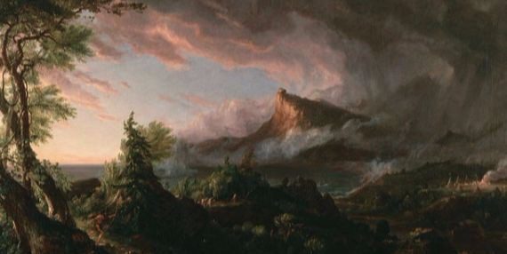 a storm coming in over a mountain lit up in shades of pink and grey