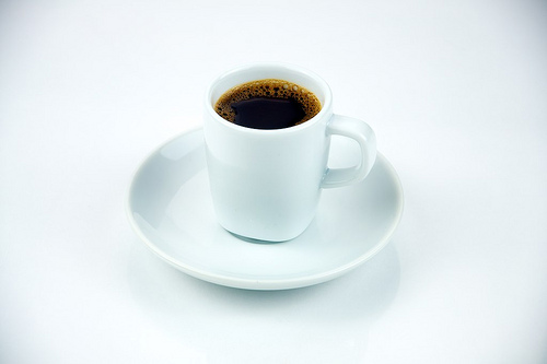 Classic Espresso in a white cup shot on a white background.