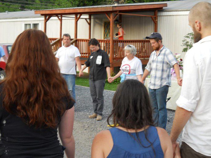 Leah Schade leading a prayer vigil held at the site of Riverdale Mobile Home Park in Jersey Shore, PA, before it was destroyed to make room for a water withdrawal plant along the Susquehanna River for the fracking industry. May 2012.