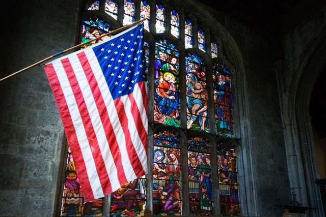 U.S. flag and church stained glass window