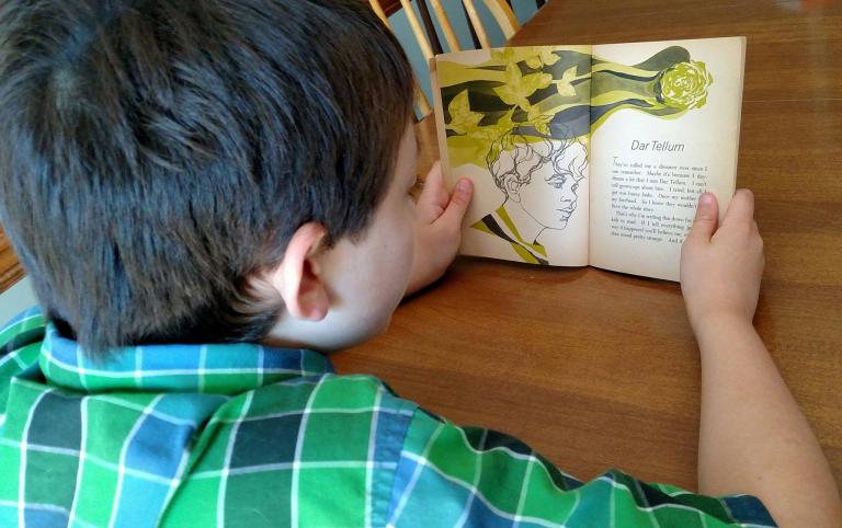 My son reading Dar Tellum. Photo credit: Leah D. Schade