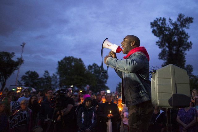 Speaker at vigil in Charlottesville following white nationalist rally. Photo by Fibonacci Blue. Some rights reserved. www.flickr.com