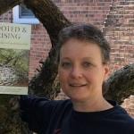 Leah D. Schade with book, Rooted and Rising
