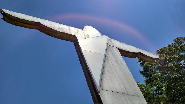Statue of Jesus against a blue sky