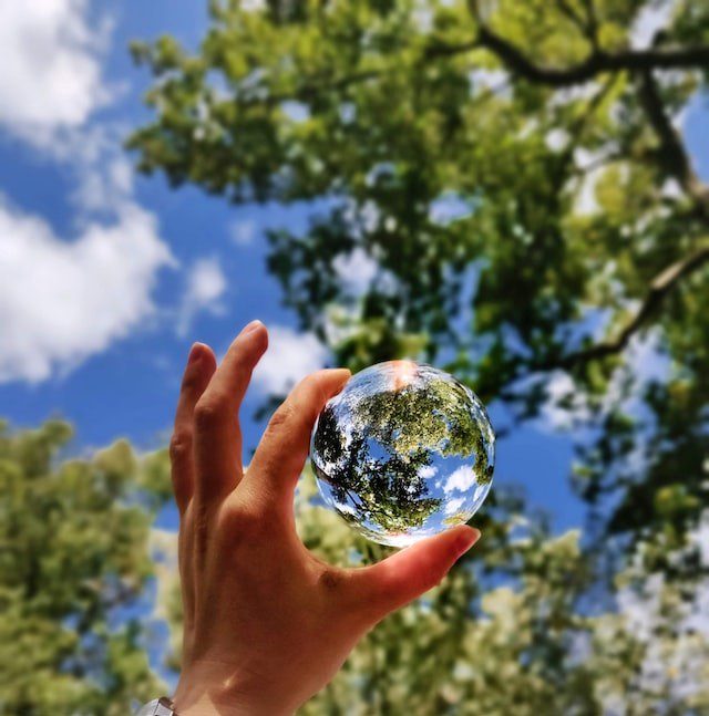 hand holding glass ball trees