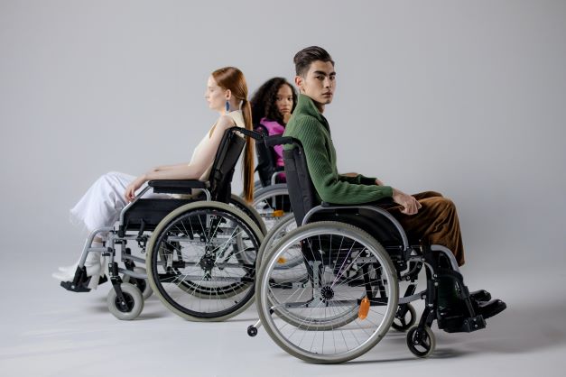 three people in wheelchairs