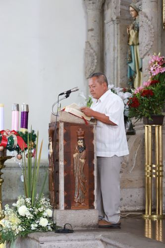 man reading prayers in church