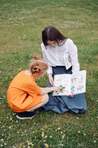 woman and child in field reading book