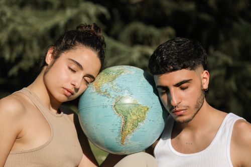 woman and man heads leaning on globe earth
