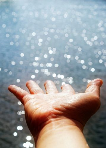 Baptismal water, light, hand