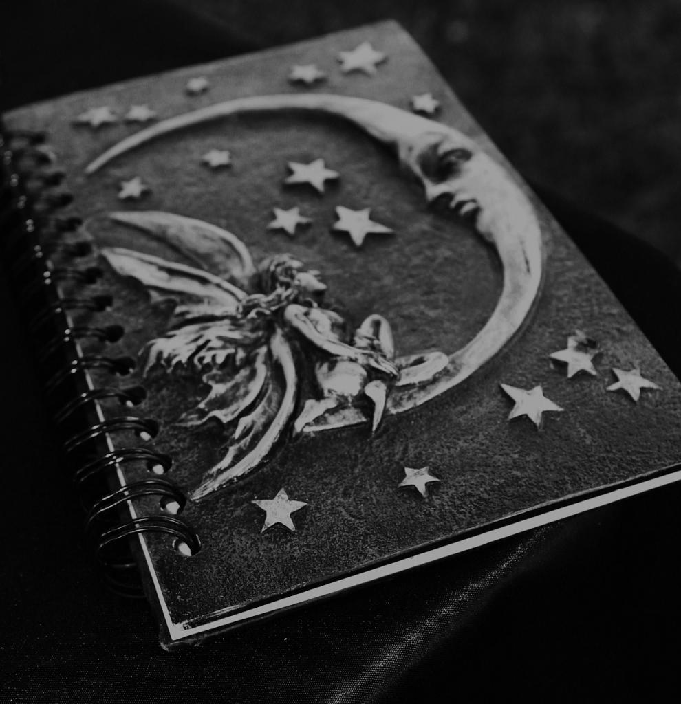 book of shadows with a faery and a moon